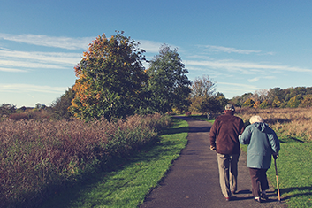 a man and woman walking outdoors with NYS Disability Insurance in White Plains, Yonkers, Long Island City, Deer Park, Farmingdale, Bohemia and Surrounding Areas